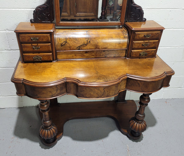 An elegant Victorian Figured Walnut dressing table with tilit mirror and a stunning fine Firgured Walnut serpentine shaped front. It has been sourced locally and is in good original detailed condition.