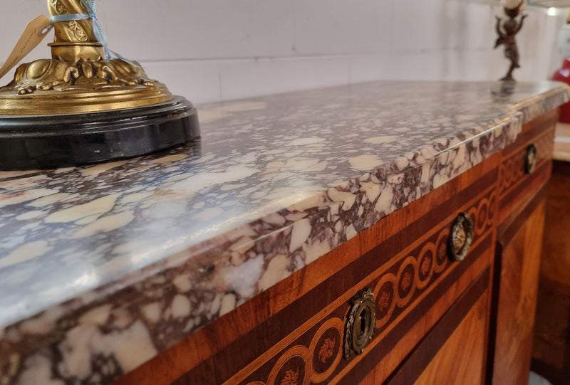 A high quality 19th Century French marquetry inlaid Kingwood marble top credenza. It has an attractive solid marble top and decorative marquetry inlay throughout. It has plenty of storage space with three drawers and three doors. It has been sourced from France and is in good original detailed condition.