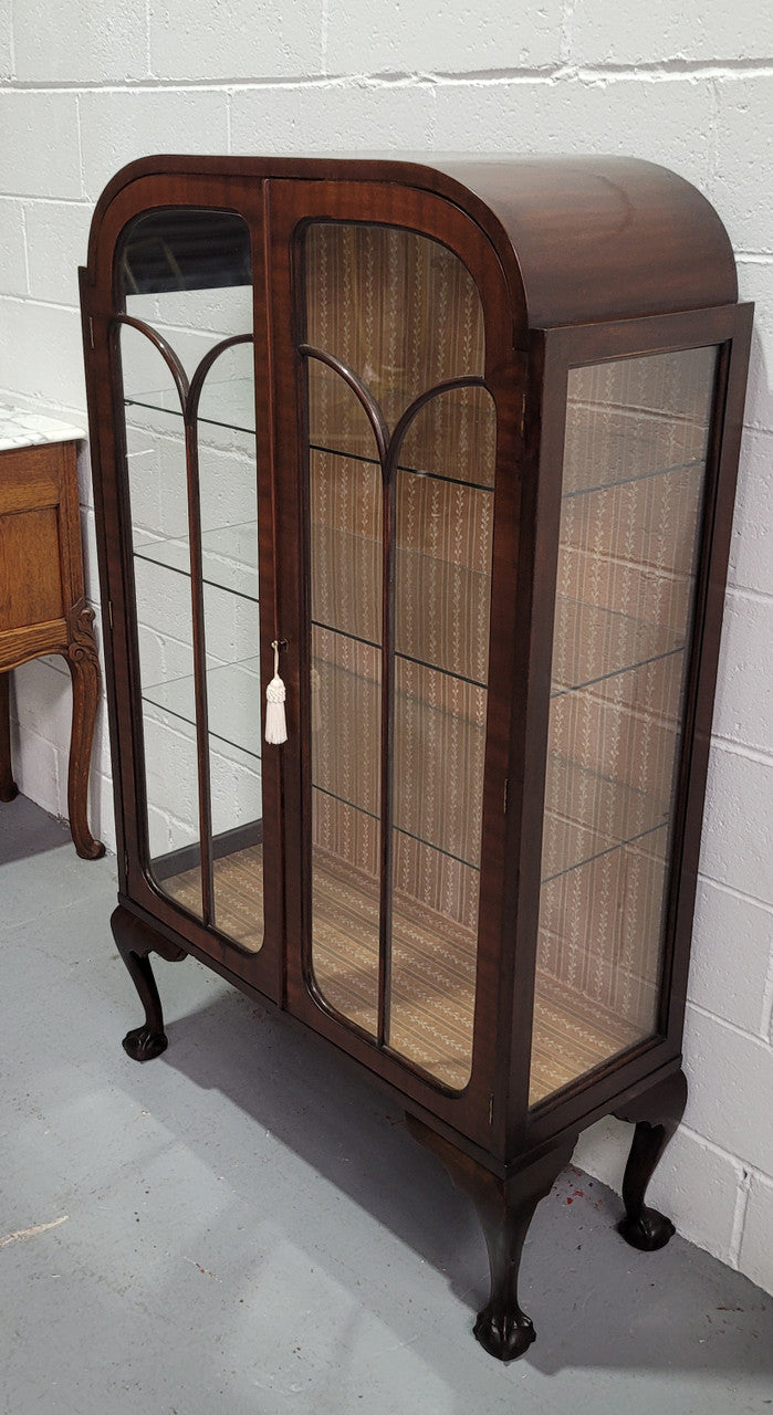 Chippendale style Walnut display cabinet of pleasing narrow portrions. It is in good original condition and comes with three shelves.
