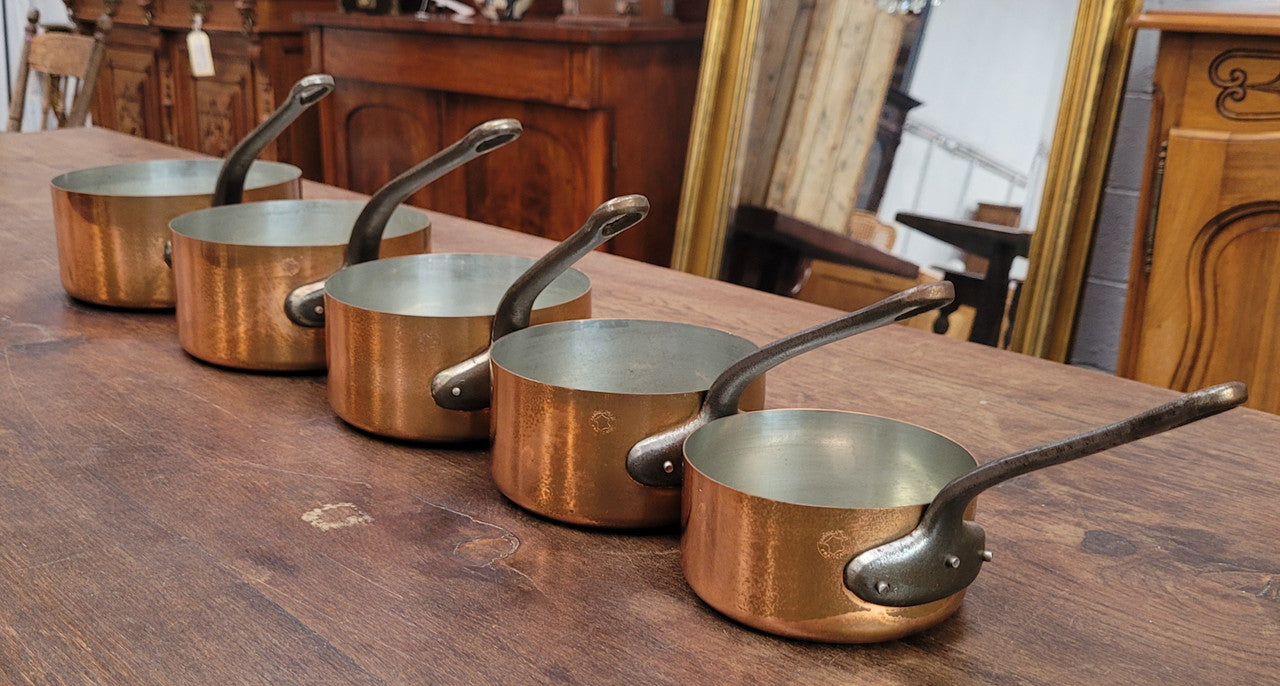 Set of five copper sauce pans with foundry stamp. They have been sourced from France and are in good original detailed condition.