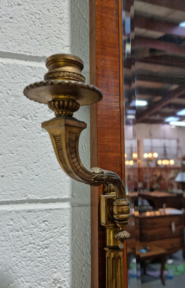 Decorative late 19th Century mahogany French wall mirror with brass swivel candle holders and brass detail. In good original detailed condition.