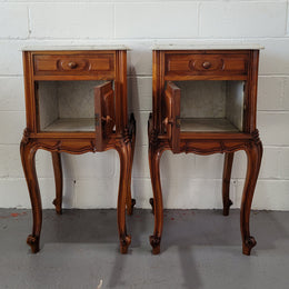 Pair of stunning Louis XV style French Walnut white marble top bedside cabinets. They have one drawer and a cupboard that is marble lined. The marble has been polished and they are in good original detailed condition.