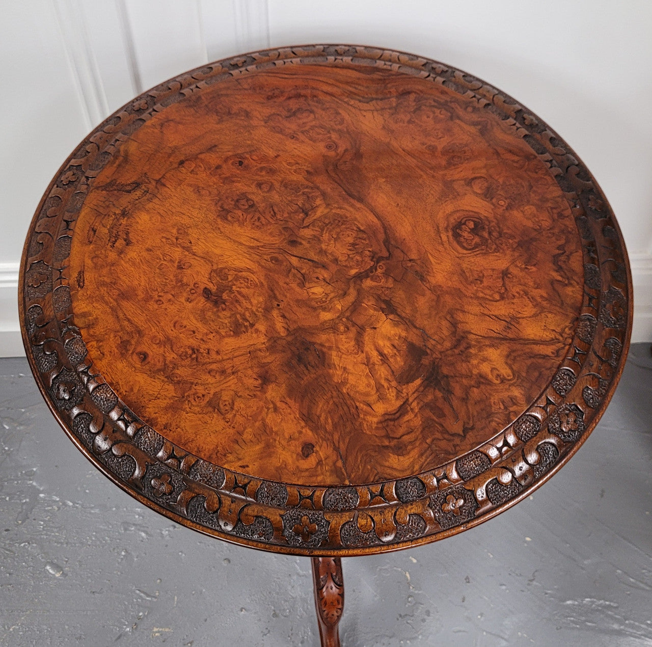 Rare early Victorian Irish Burr Walnut wine table. It has a beautiful carvings and a stunning burr walnut top, on a barley twist column and three shaped legs. It has been sourced locally and is in good original detailed condition. We also have a second table being sold separately which when together make a matched pair.