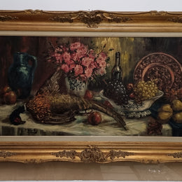Sourced from France is this beautiful large oil on canvas of fruit flowers and a pheasant in a decorative guilt frame and signed . In good original condition.