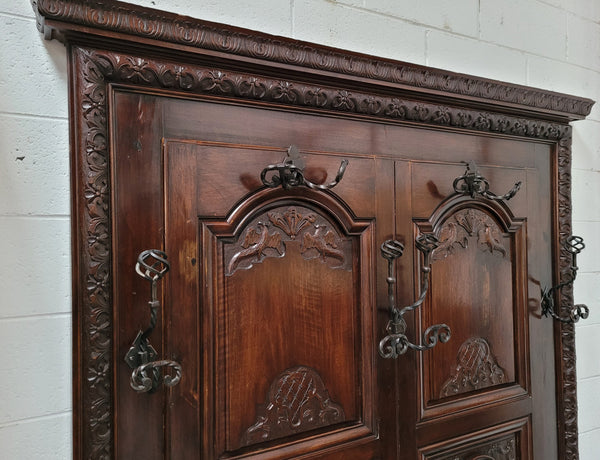 French Henry II 19th century narrow proportioned Walnut hall stand. Full of Character with stunning hand forged wrought iron hooks and interesting carvings. In good original detailed condition.