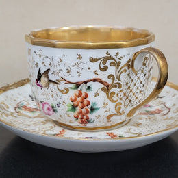 “Old Paris Porcelain” large cup and saucer, beautifully decorated with birds, grapes, floral sprays and heavily gilded. Dated to base 1835. In good original condition please view photos as they help form part of description.