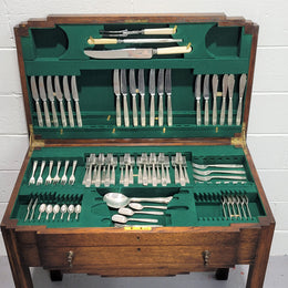 English Oak beautifully fitted cutlery table with a lift up top and drawer. Contains extensive silver plate part cutlery service by Elkington. In good original condition.