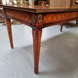 Beautiful French Louis XVI style inlaid coffee table with a brass band and glass top. In good original detailed condition.