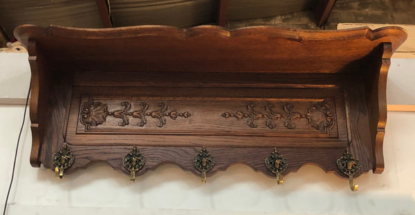 Beautiful French carved coat/hat rack with five decorative brass hooks and lovely detail in good condition.