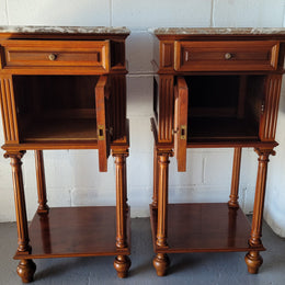 Pair of Henry II style Walnut bedside cabinets with a marble top. Circa 1920s and in good original condition.