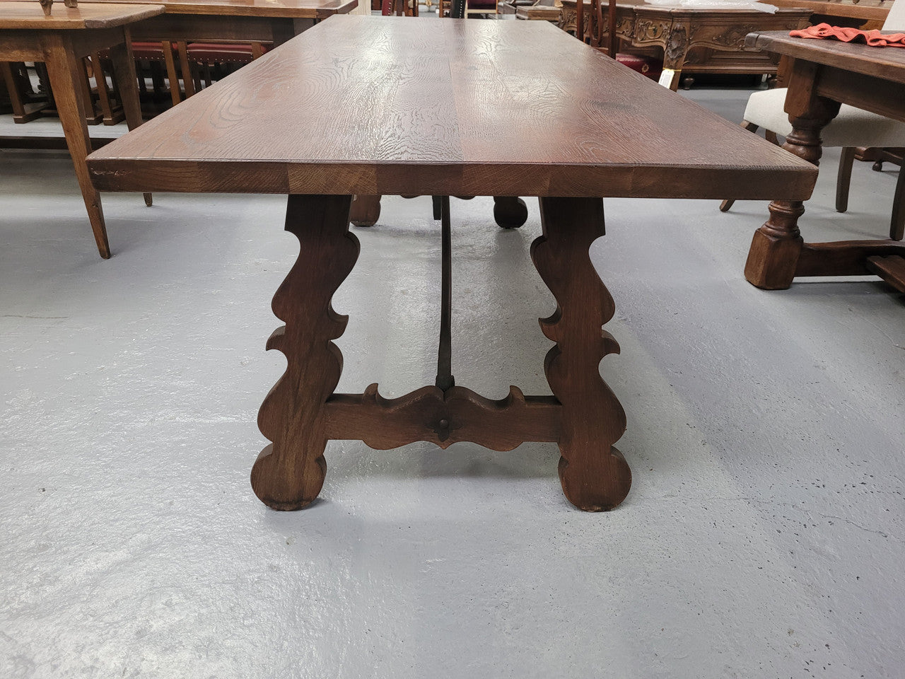 Spanish style French Oak farmhouse table with ironwork underneath. It is in good original detailed condition and has been sourced from France.