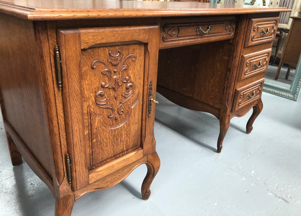 Beautifully carved French oak small desk with three drawers and a cupboard for all your storage needs. In good original condition. Great size for small spaces.