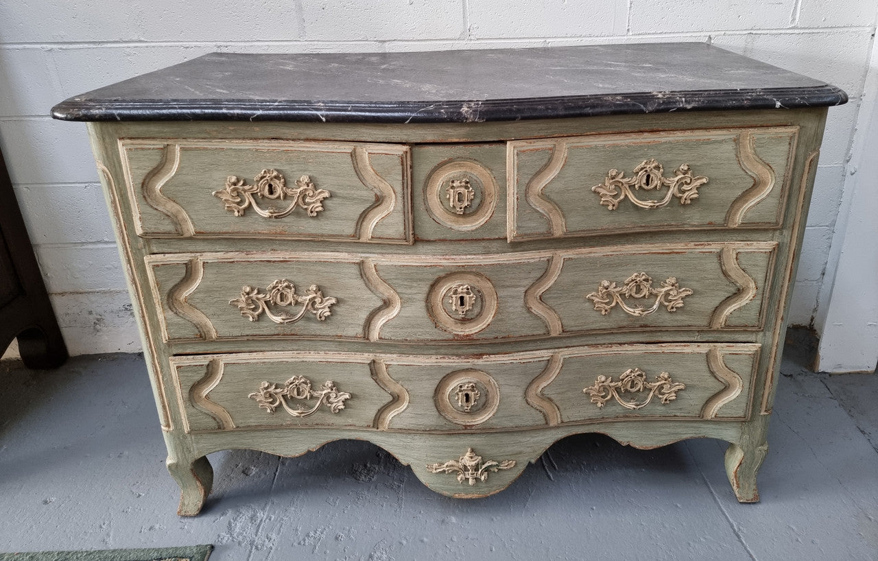 Early 19th Century Louis XIV style faux marble top and painted base commode. It is of large proportions and has four drawers. In good original detailed condition.