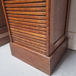 Antique Edwardian roll top Tambour file cabinet desk. This practical antique tambour front filing cabinet dates around 1900 in the Edwardian period and is constructed from Oak. This antique cabinet has an adjustable writing slope, above a tambour front with key and working lock. It has been sourced locally and is in good original detailed condition.