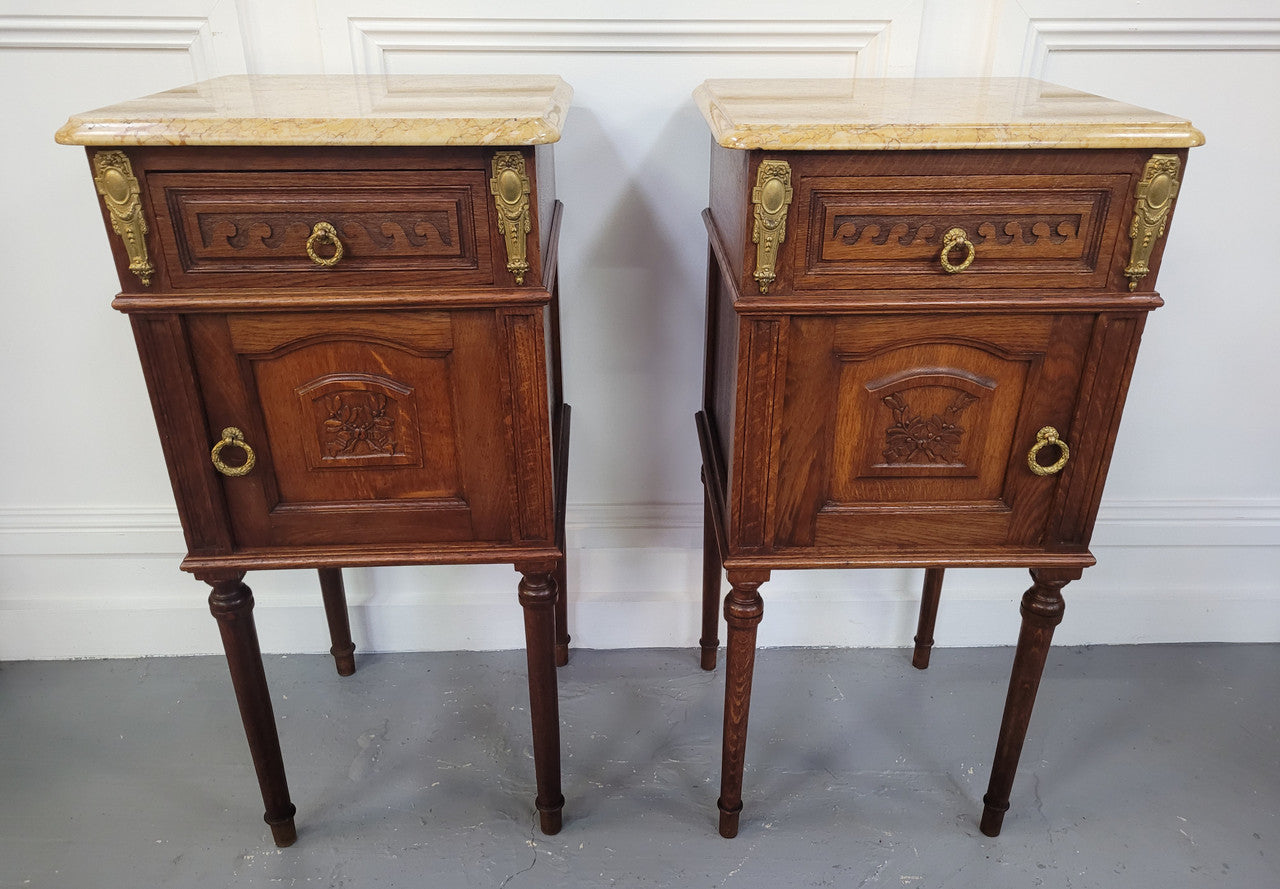 French Oak pair of Louis 16th style marble top bedsides with stunning bronze mounts. They have been sourced from France and are in good original detailed condition.