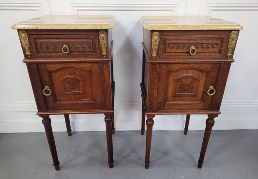 French Oak pair of Louis 16th style marble top bedsides with stunning bronze mounts. They have been sourced from France and are in good original detailed condition.