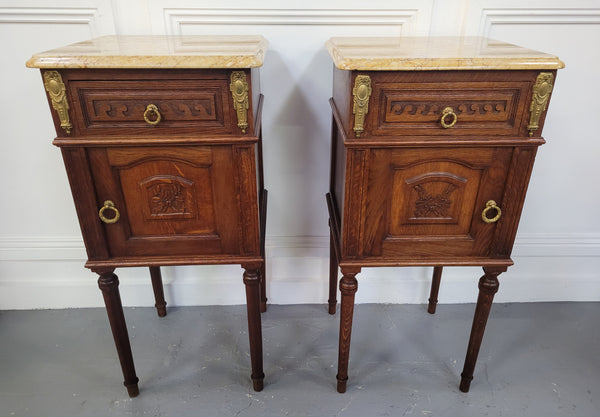French Oak pair of Louis 16th style marble top bedsides with stunning bronze mounts. They have been sourced from France and are in good original detailed condition.