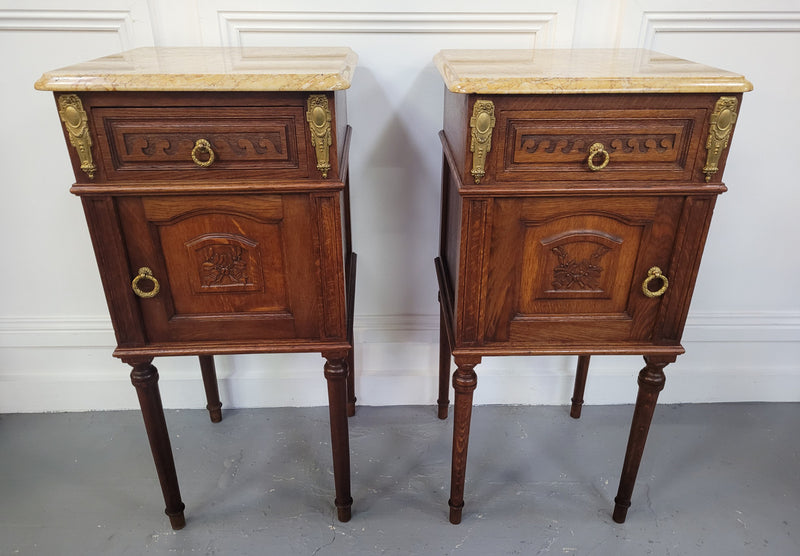French Oak pair of Louis 16th style marble top bedsides with stunning bronze mounts. They have been sourced from France and are in good original detailed condition.