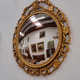Vintage large round ornate convex mirror. Lovely gilt decoration around and is in good original condition.
