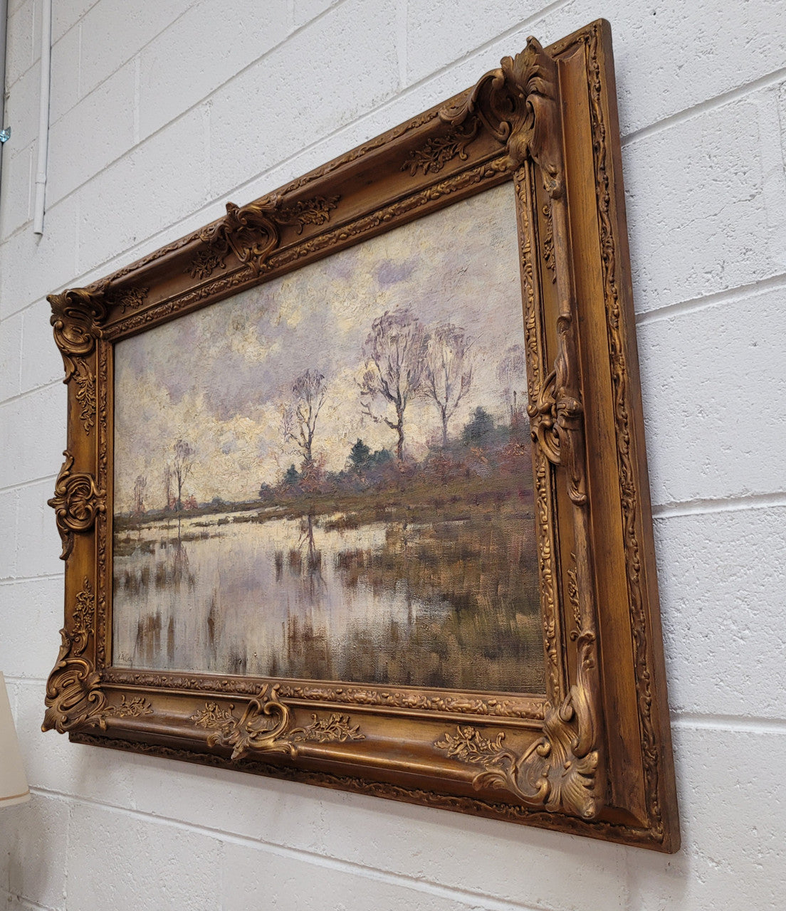 Sourced from France an impressionist oil painting of a beautiful lake scene. It is nicely framed in an Antique frame and in good original detailed condition.