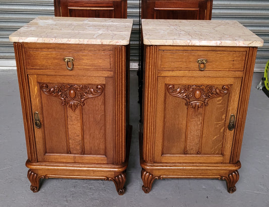 Pair of French Oak Art Deco marble top bedsides. They have amazing carvings and plenty of storage with a cupboard and drawer. They are in good original detailed condition.