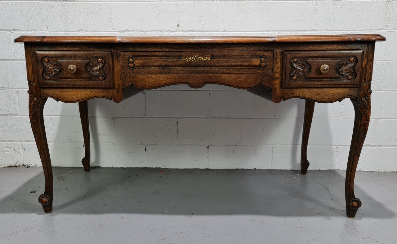 Attractive large Louis XV style Oak faux partners desk. Nicely carved details with three large functioning drawers, and three faux drawers at the back. In good original detailed condition.
