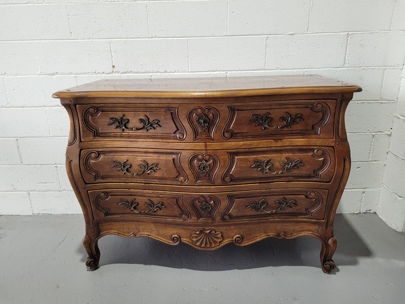 Impressive French Louis 15th style three drawer Commode featuring inlaid parquetry top and carving on drawers.