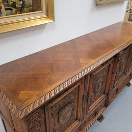 Large French Oak Renaissance style four door sideboard/buffet. Great decorative item with amazing carvings and stunning iron work on base. It is in good original detailed condition. Can pull apart completely making it easier to move.