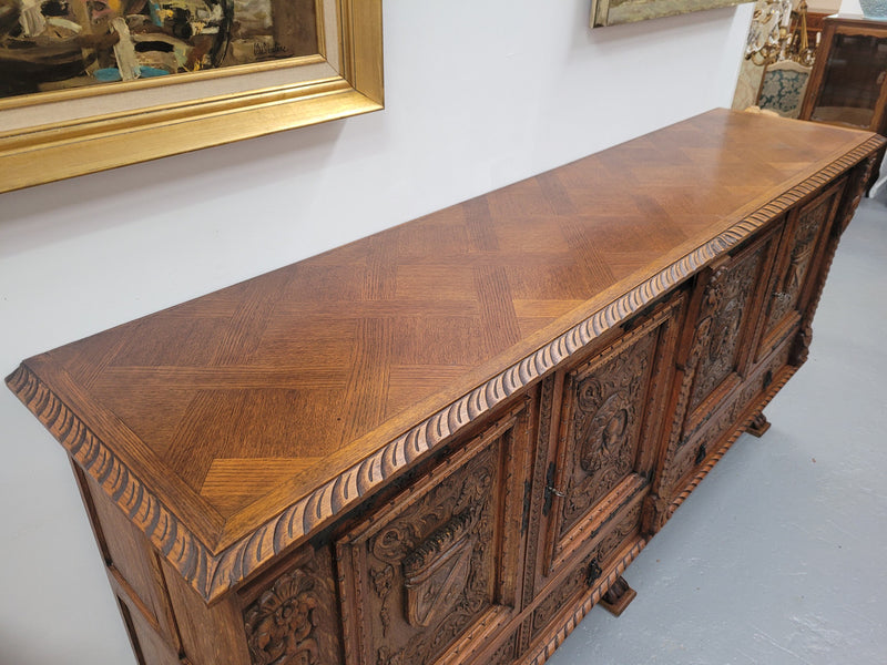 Large French Oak Renaissance style four door sideboard/buffet. Great decorative item with amazing carvings and stunning iron work on base. It is in good original detailed condition. Can pull apart completely making it easier to move.