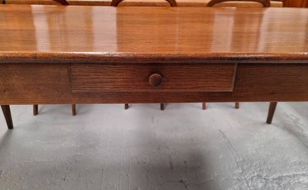 Antique French Oak Farmhouse table in fully restored condition. Features a single drawer and tapered legs.