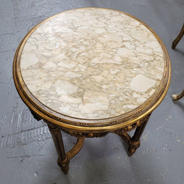 French Louis XVI style round marble topped gilded lamp/side table featuring lovely carved swags and undercarriage. It has been sourced from France and is in good original detailed condition.