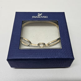 Swarovski gold toned fitted bangle set with Swarovski crystals. Swarovski mark to band, and a side opening. Charming little bracelet. Please see photos as they form part of the description.