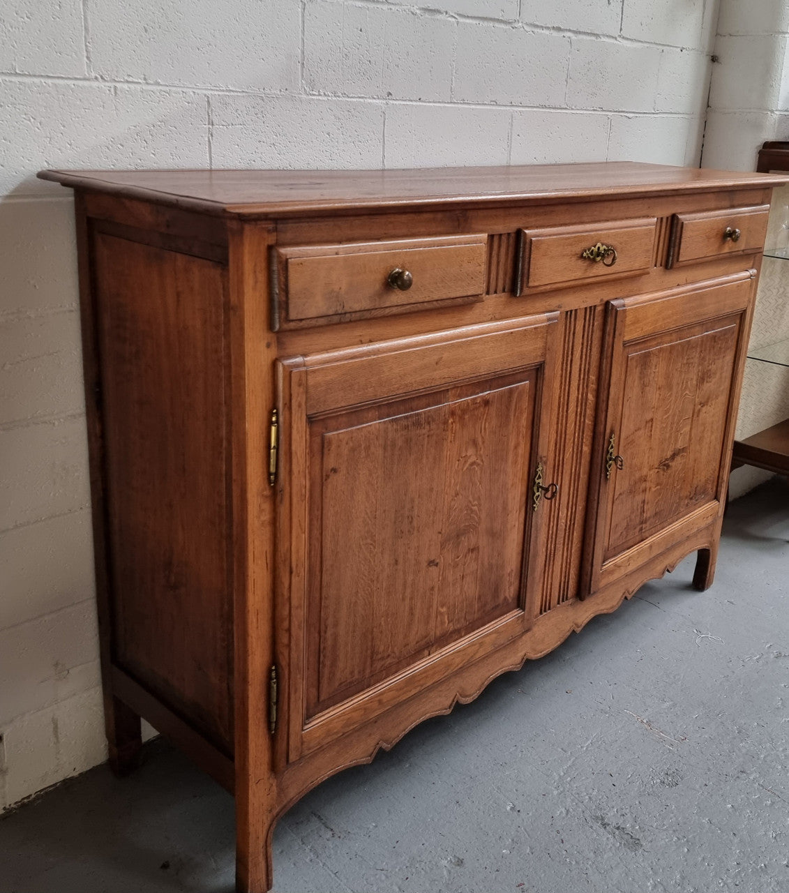 French Oak Early 19th Century sideboard with two doors and three drawers. In good original condition.