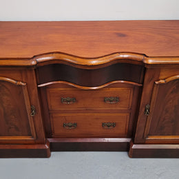 An English Victorian Mahogany sideboard with nine drawers. This amazing piece has loads of storage with three central drawers in the middle and a further six drawers. It has three each side located behind two doors. It has been sourced from locally and in original detailed condition.