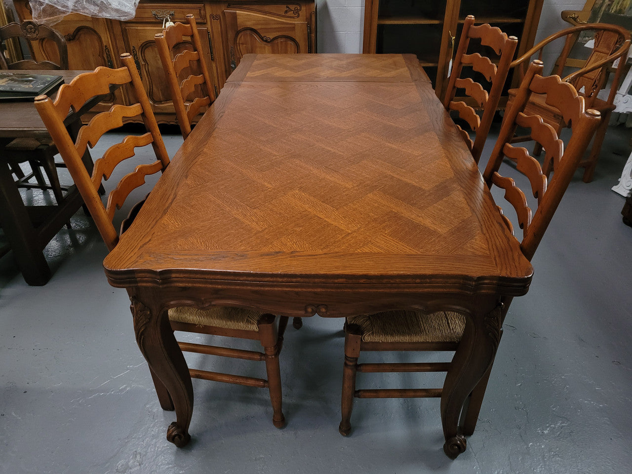 French Oak Louis XV style parquetry top extension table. It can sit six people when not extended and eight when fully extended. It has been sourced from France and is in original detailed condition.