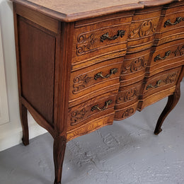 Vintage French dark Oak Louis XV style chest of three drawers. It has beautiful cabriole legs, elegant brass handles and decorative carving throughout. It is in good original detailed condition and has been sourced from France.