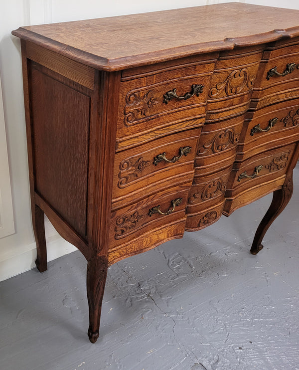 Vintage French dark Oak Louis XV style chest of three drawers. It has beautiful cabriole legs, elegant brass handles and decorative carving throughout. It is in good original detailed condition and has been sourced from France.