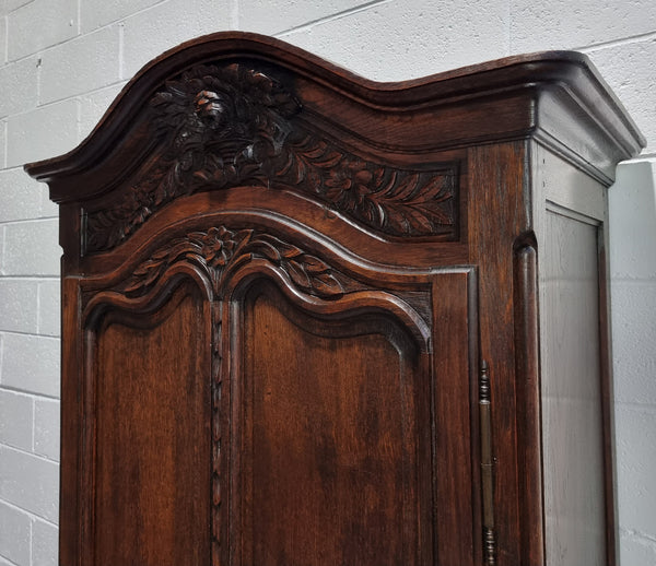 An Attractive French Louis XV style single-door ‘Marriage Armoire’. Beautifully arched crest with detailed carved flowers along with an arched single door which repeats the floral carvings. It is also has plenty of storage space with three adjustable shelves along with a drawer at the bottom. All in good original detailed condition.