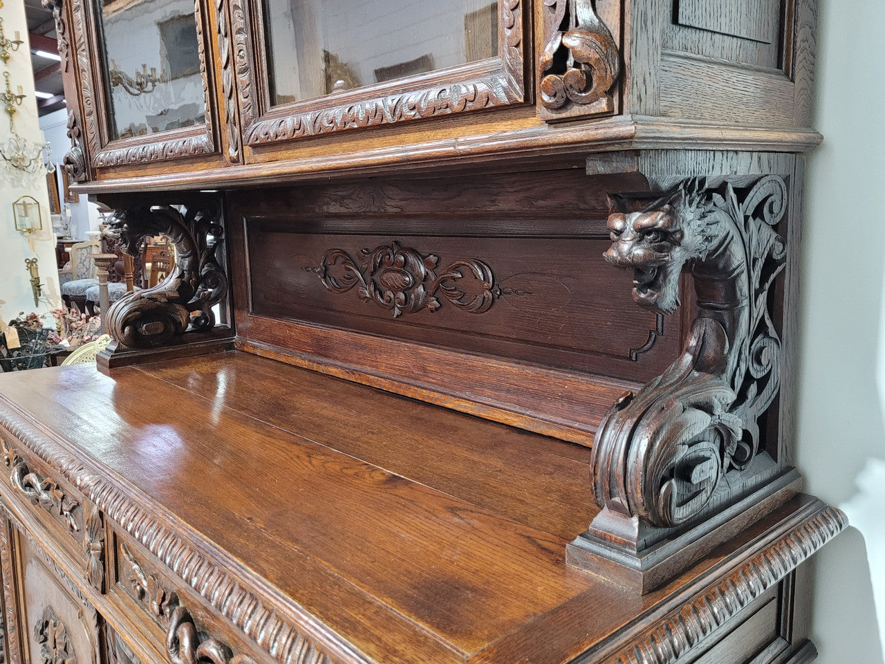 Grand French Oak Gothic style buffet with amazing detailed carvings. This stunning buffet has a display section at the top with two adjustable shelves, two drawers in the middle with elegantly carved handles and storage below with one fixed shelf. It is in good original detailed condition.