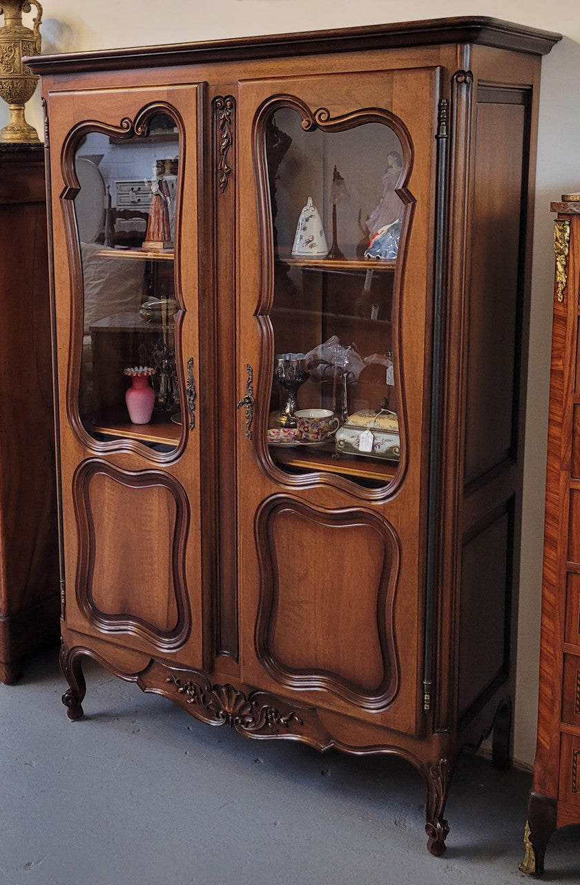 French Walnut Louis XV Style two half glass, door bookcase with three adjustable shelves. Sourced from France and in good original detailed condition.