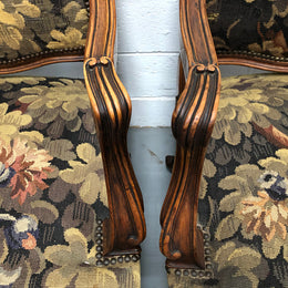 Pair of 19th Century French walnut tapestry covered arm chairs. They are in good original condition. Circa 1890.
