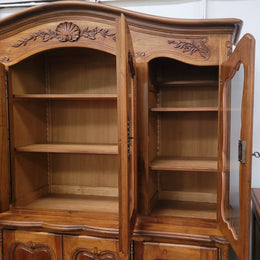 Magnificent French Walnut two-body four door display cabinet. Heaps of storage space with four glass doors at the top with shelves and four solid doors below also with shelving. It has been sourced from France and comes with a key for each door and all are lockable. In good original detailed condition.