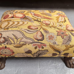 Lovely Upholstered Georgian footstool with feet. It has been sourced locally and is in good original condition.