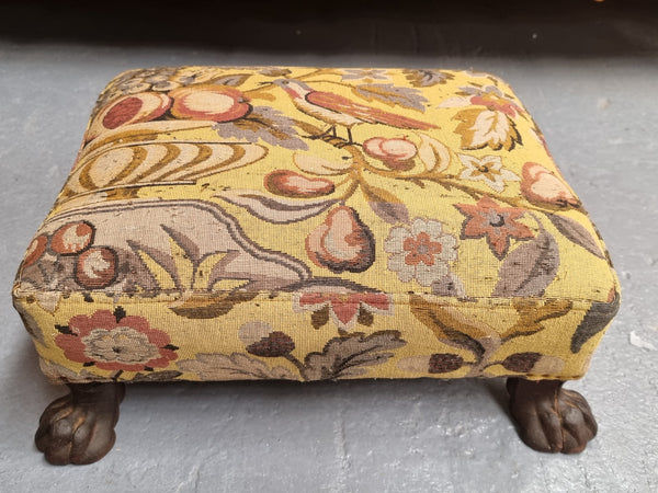 Lovely Upholstered Georgian footstool with feet. It has been sourced locally and is in good original condition.