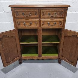 French Oak Louis XV style side cabinet. It has three drawers in total, two small drawers and one deep drawer. In good original detailed condition.