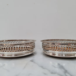 Gorgeous pair of vintage silver plate wine coasters with stunning turned wooden base. Not marked. In great original condition.