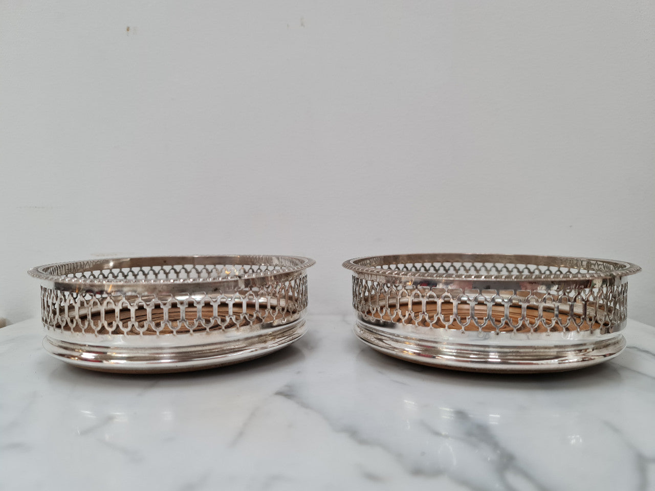 Gorgeous pair of vintage silver plate wine coasters with stunning turned wooden base. Not marked. In great original condition.