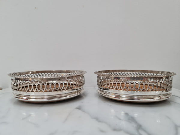 Gorgeous pair of vintage silver plate wine coasters with stunning turned wooden base. Not marked. In great original condition.