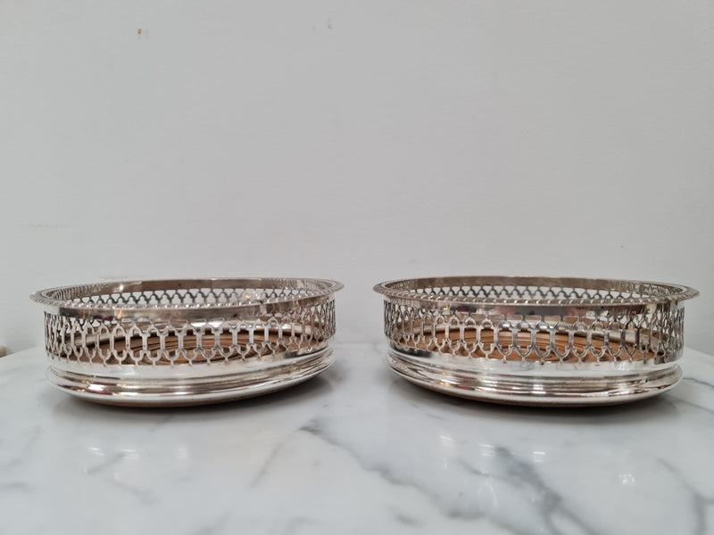 Gorgeous pair of vintage silver plate wine coasters with stunning turned wooden base. Not marked. In great original condition.