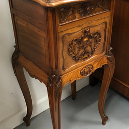 Single French carved bedside with inset marble top. It has beautiful carving and a drawer and cupboard for storage. In very good original detailed condition.